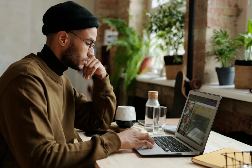 Focused digital professional working on a laptop in a cozy workspace