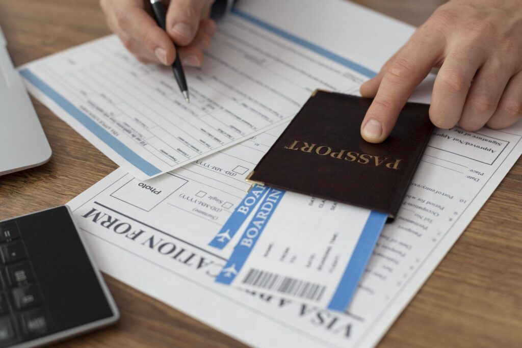 Close-up of a traveler filling out a visa application form with passport and boarding pass