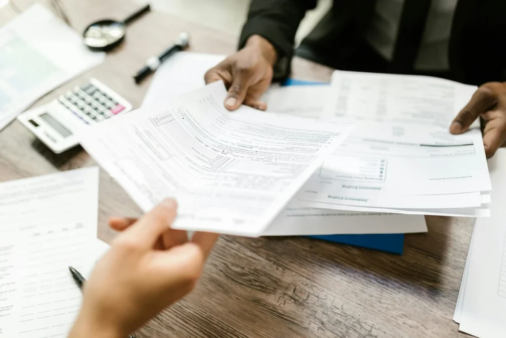 Foreign investors reviewing BOI application documents with a consultant during a business meeting.