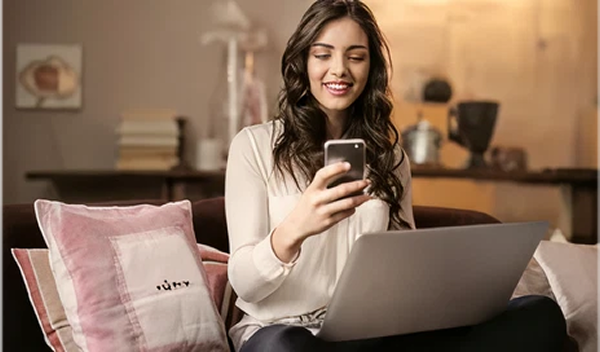 Professional using digital devices while working from home in Thailand under Long-Term Resident Visa