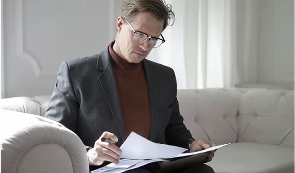 Foreign investor reviewing documents for Thailand BOI company application