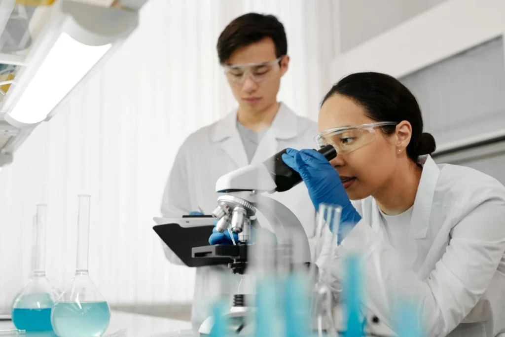 International researchers working in a laboratory with microscope and test tubes